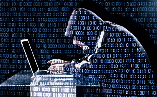 Hacker Typing On A Laptop